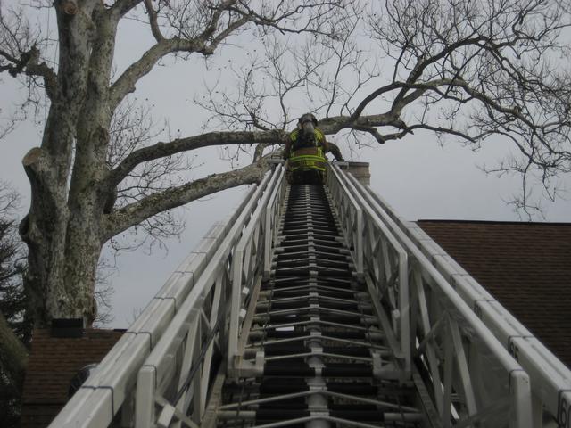 Firefighter Mike Nelson operates on Ladder 21 at a chimney fire on Newark Road.